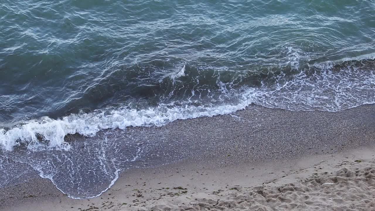 海浪翻滚到岸边，从上面看视频素材