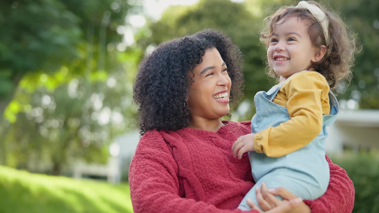 家庭，孩子和一位母亲和她的养女在他们的寄养家庭的花园在一起。爱，微笑和孩子，继母抱着她的女儿在屋外的后院视频素材