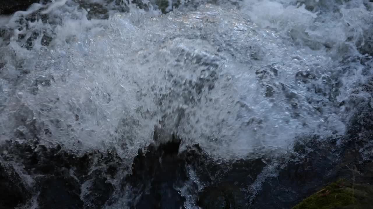 河中的瀑布。水流靠近。河水撞击岩石。慢动作的河水飞溅视频素材