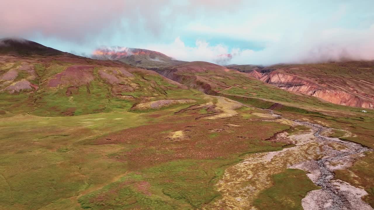 冰岛东部日落时，Borgarfjordur Eystri草谷上翻滚的云。无人机航拍视频素材