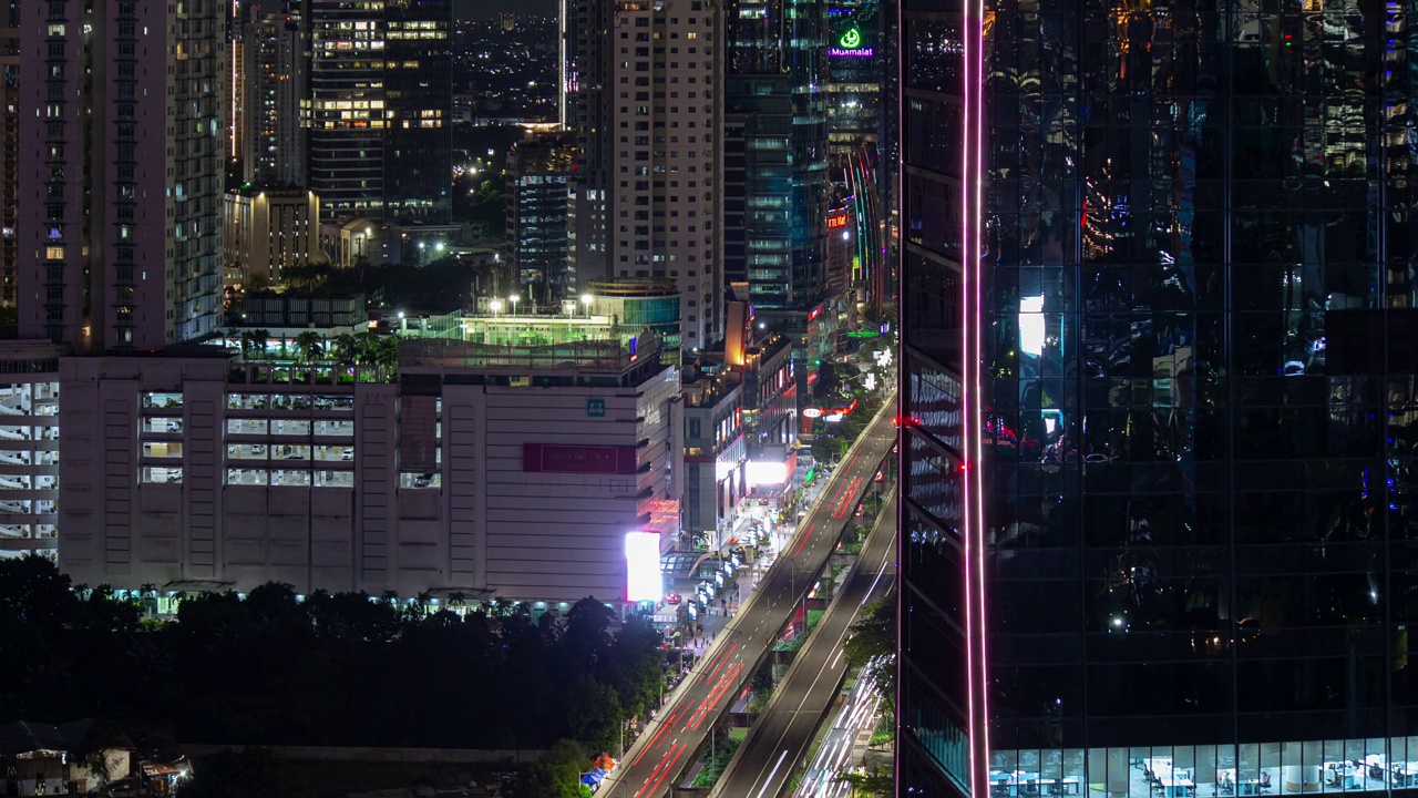 夜间照明雅加达市中心办公大楼交通街道屋顶全景4k延时拍摄印度尼西亚视频素材