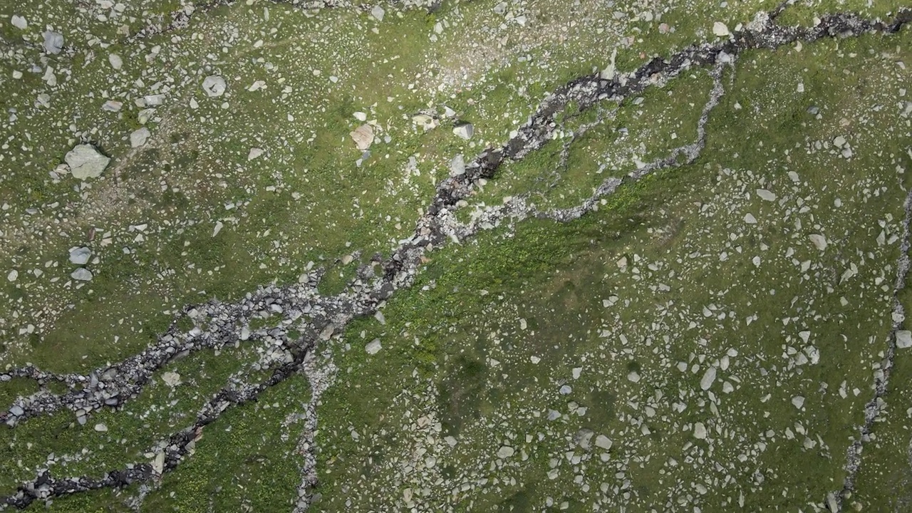 在高山牧场的岩石河上旋转航拍视频素材