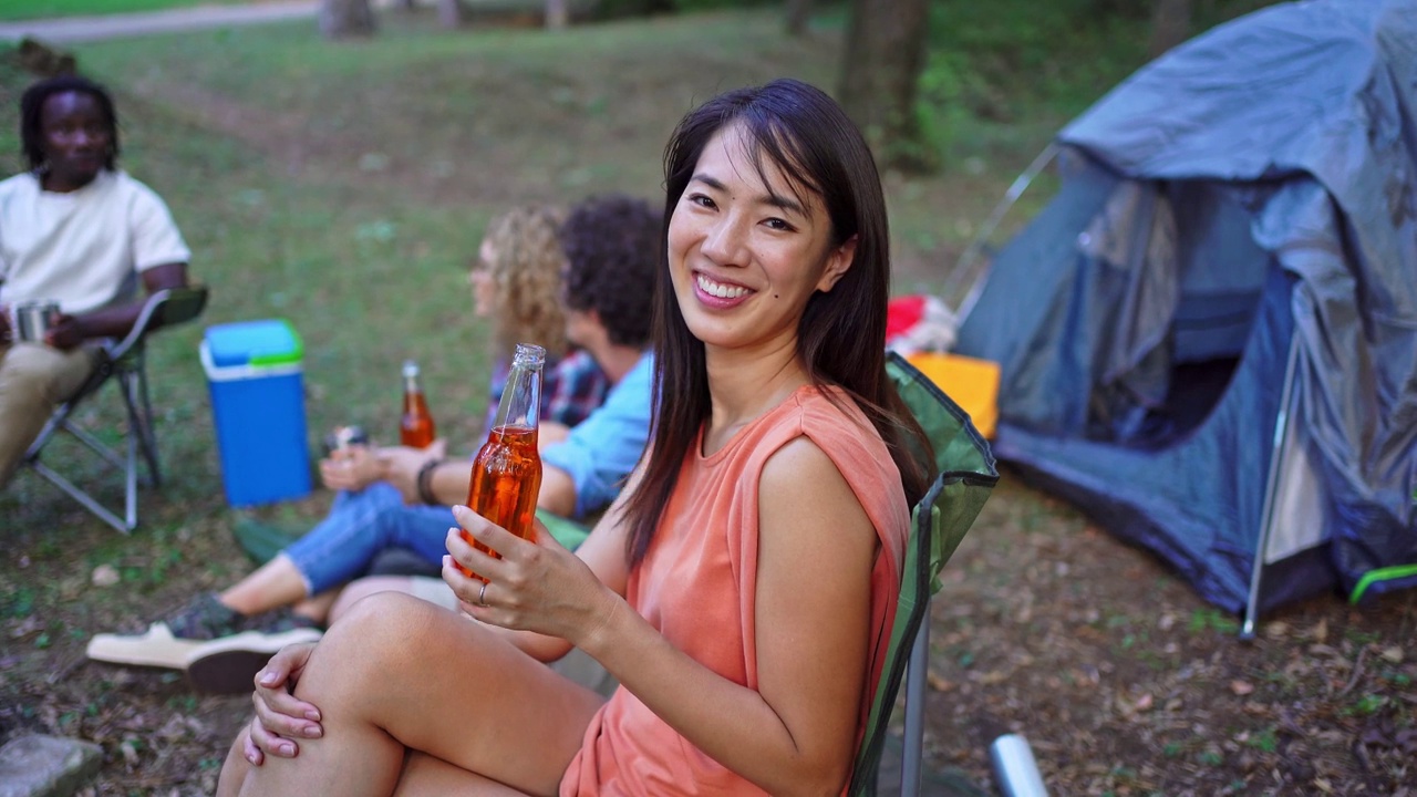 一个女人和朋友在森林里露营时的肖像视频素材