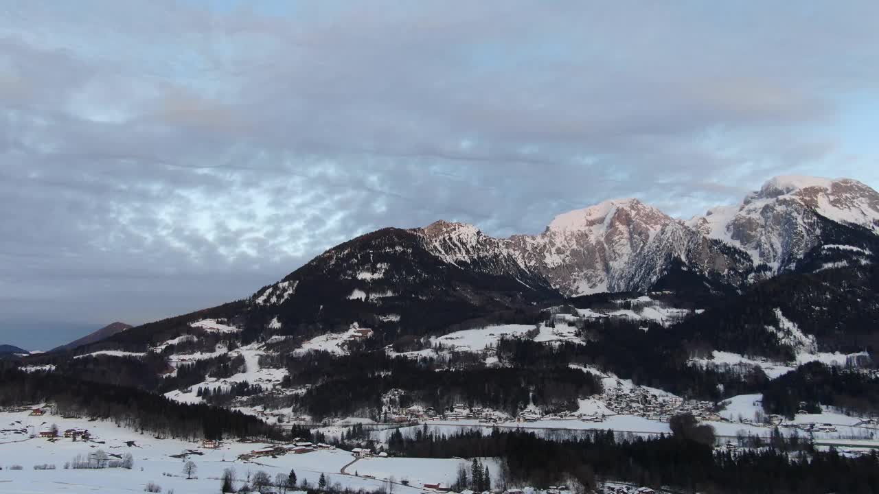 一座大山的航拍画面，有雪峰和许多树木，4k视频素材