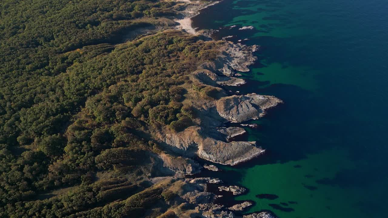 鸟瞰图，保加利亚黑海的岩石，荒凉的海岸，有悬崖，海滩和绿色的森林视频素材