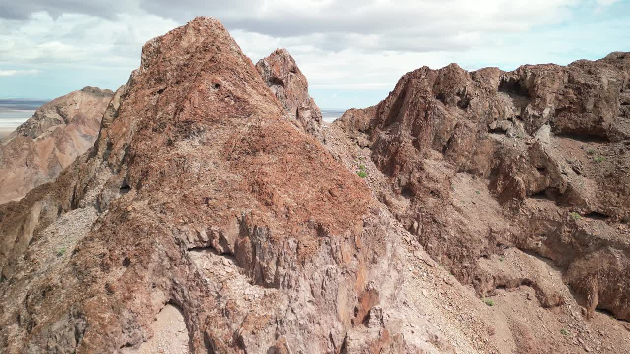 鸟瞰巴哈科尔特斯海上方山峰的红色参差不齐的山峰视频下载