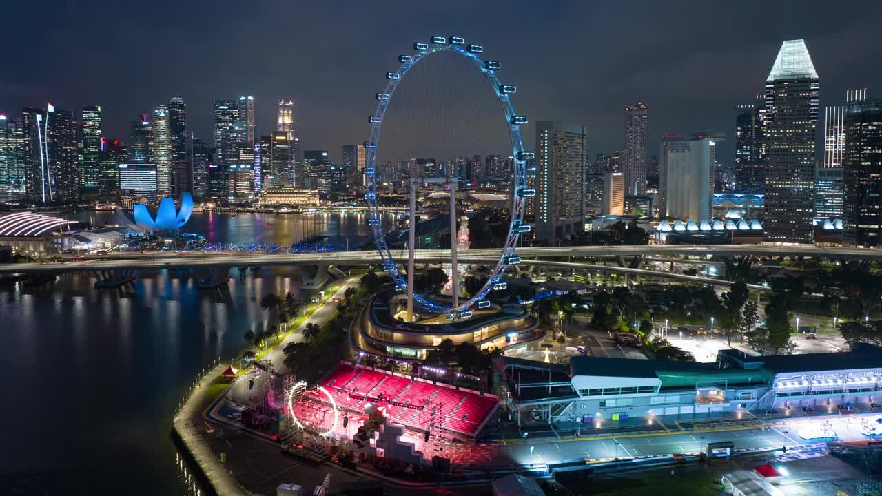 夜景新加坡城市著名摩天轮灯光秀湾航拍全景4k延时拍摄视频素材