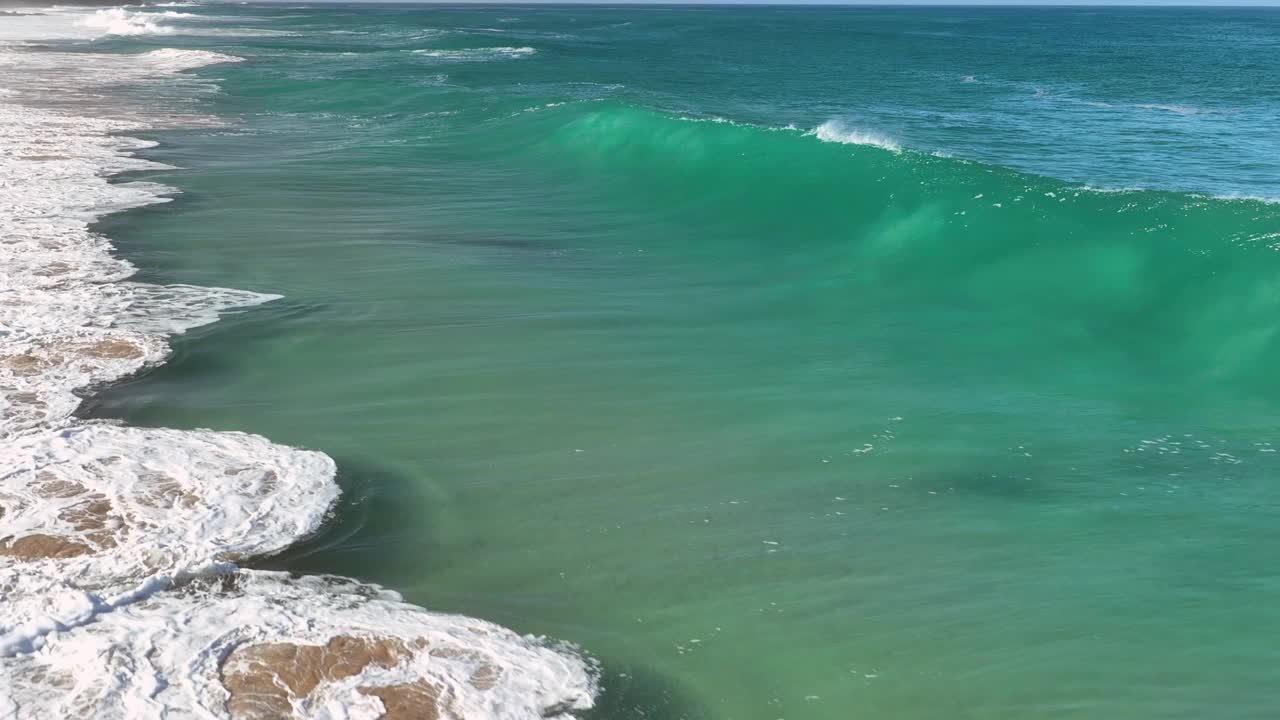 鸟瞰美丽的海水浪花飞溅。巨大的海浪慢动作视频素材