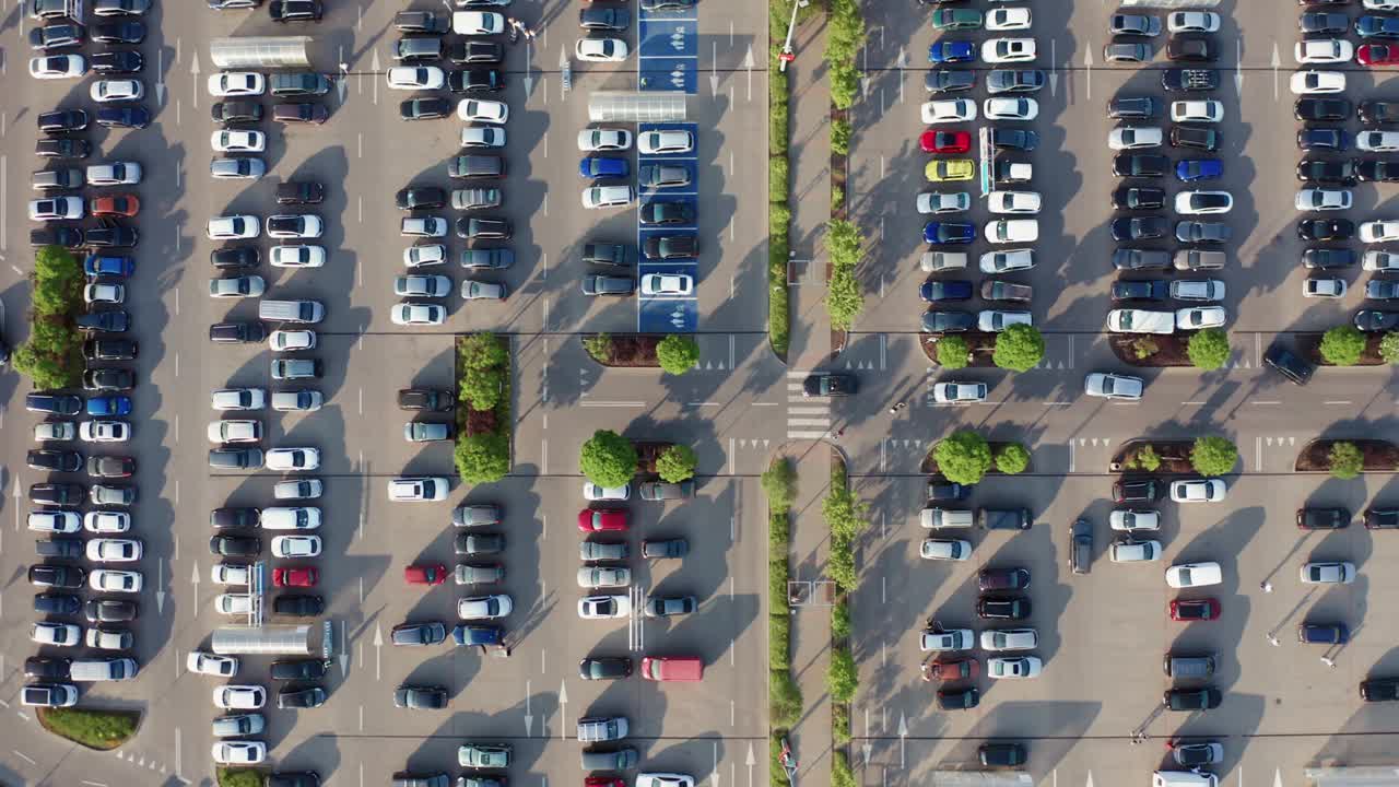 空中无人驾驶飞机在城市大型购物中心附近停车，汽车交通，停车头顶俯视视图视频素材