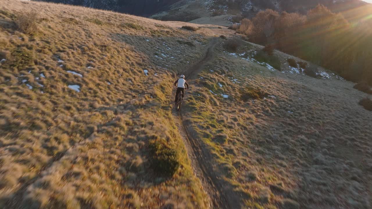 高空无人机拍摄高山山脊上的山地自行车手视频下载