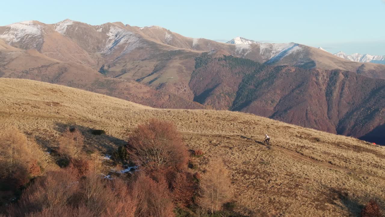 高空无人机拍摄高山山脊上的山地自行车手视频下载