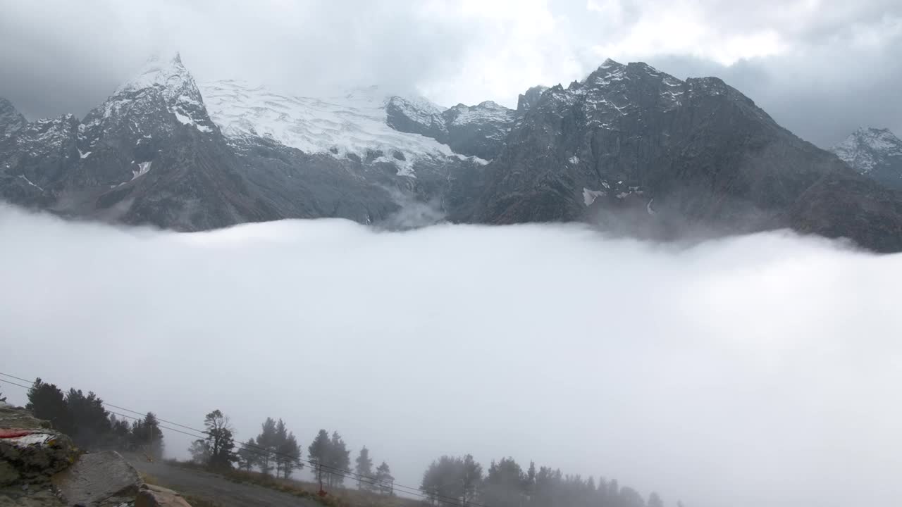 雪山中移动的云的时间差。有创造力。覆盖在雪山上的云朵。多云天气时，落基山脉雪峰下的积云视频素材