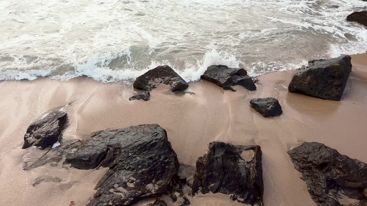 海浪冲击着海岸线上的天然岩层。无情的海浪遇到了崎岖的风化岩石。原始自然概念。视频素材