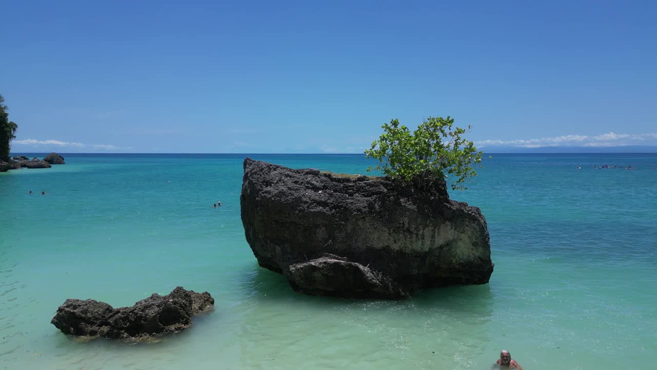 在印度尼西亚巴厘岛乌鲁瓦图海岸附近的一块岩石附近飞行。天线。视频素材