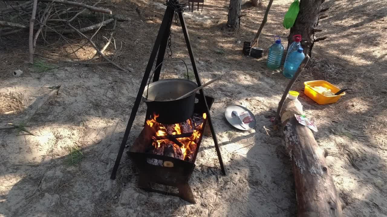 露营。用大锅在火上烹调食物。视频素材