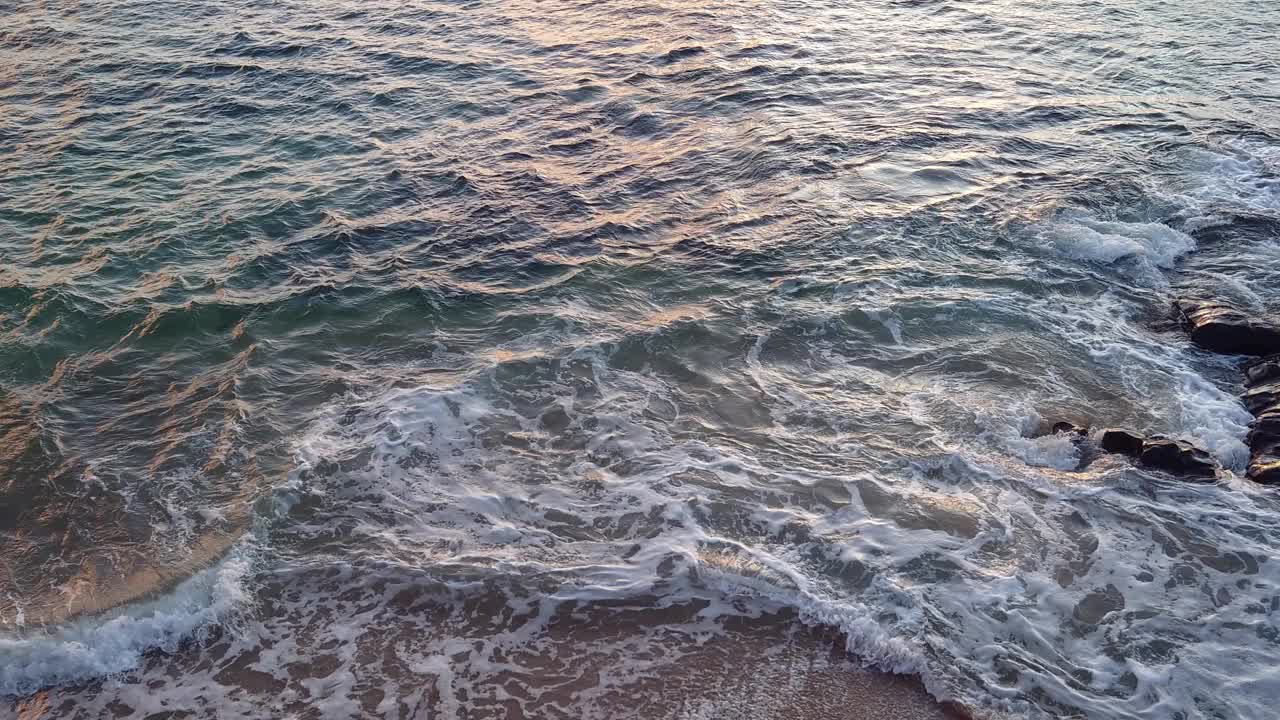 海浪在白天冲击着岩石。夏日日落海景视频素材