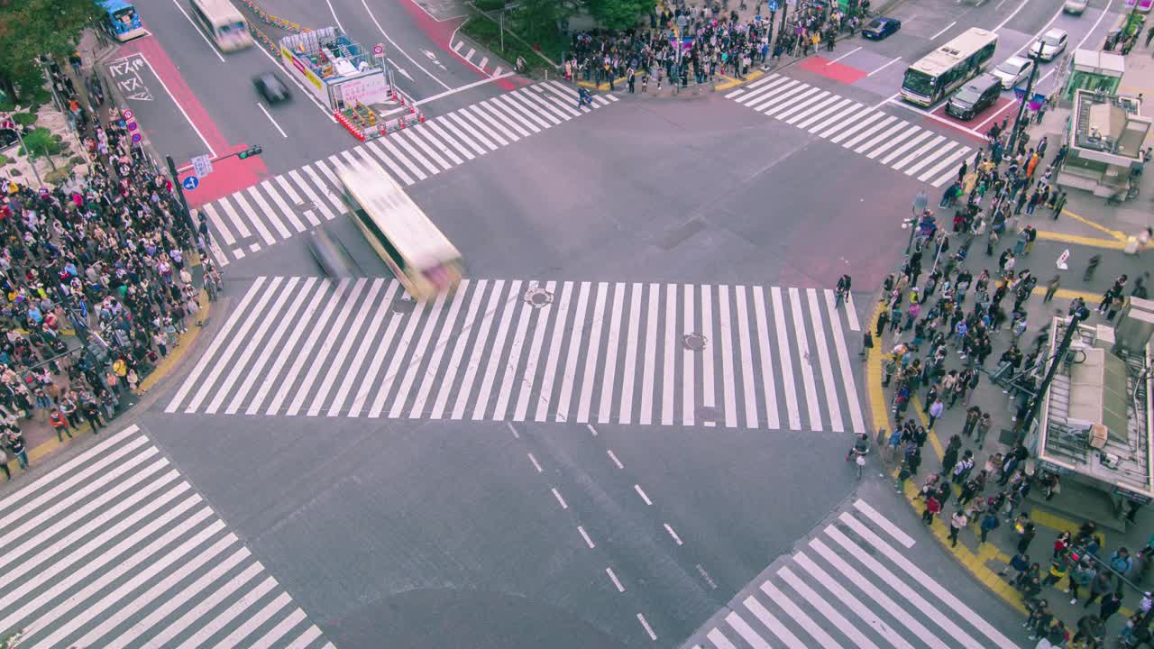 在日本东京，白天，涩谷十字路口有许多行人和车辆穿过十字路口。涩谷时尚购物娱乐东京旅游景点地标，日本旅游胜地。视频下载