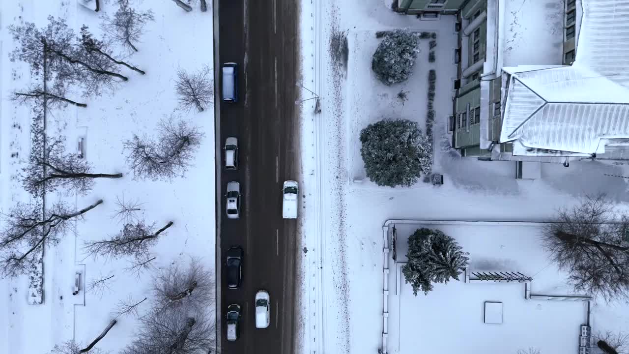 鸟瞰乌克兰冬季城市第聂伯罗和积雪覆盖的汽车交通街道。视频下载