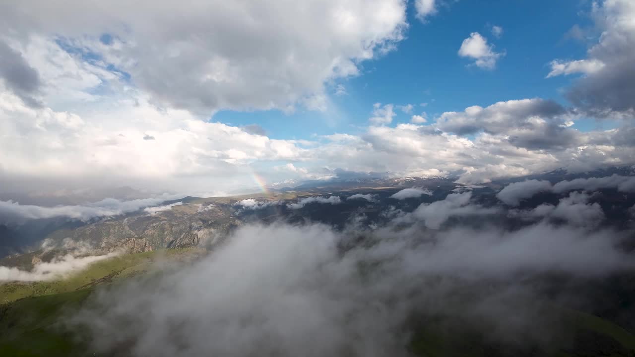 山间彩虹鸟瞰图，雨中彩虹飞翔图，山间彩虹鸟瞰图，山间彩虹鸟瞰图，雨后戏剧性的山云视频素材