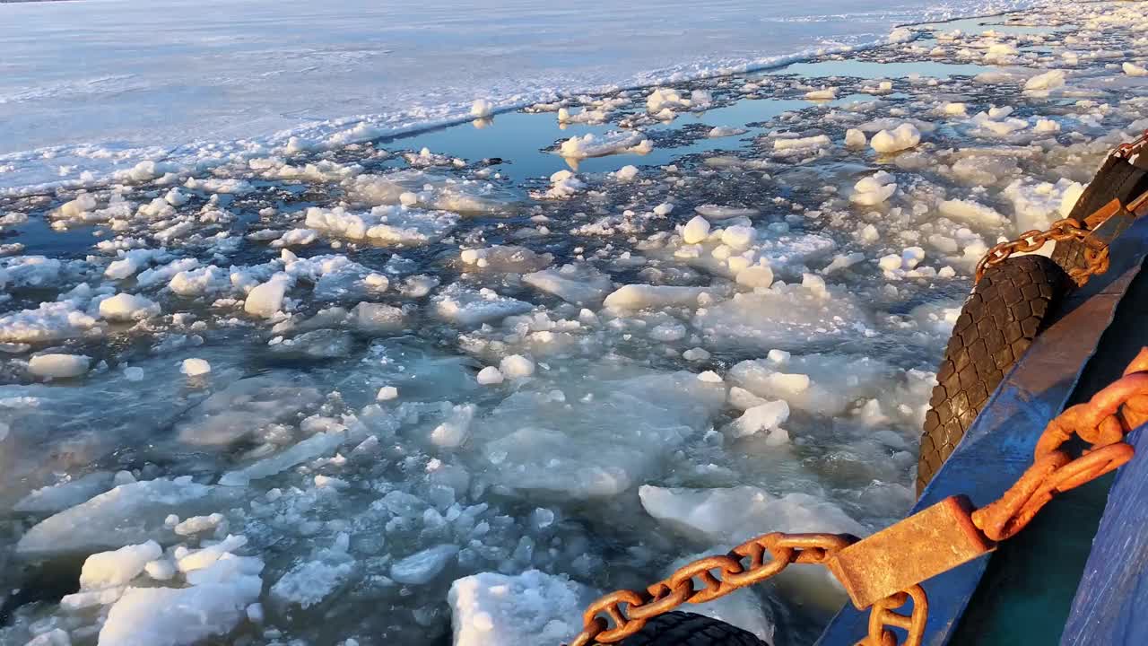 景观从一侧的河流拖船，同时移动期间的冰漂流，漂浮在河上的碎浮冰。视频下载