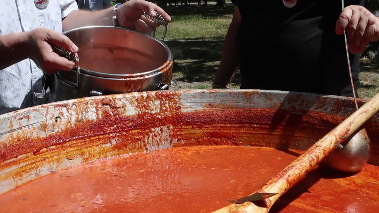 西红柿汤和意大利面是一道波兰菜。在食品博览会上，野地厨房里的大锅里盛着热祖帕。一种受欢迎的汤，用磨碎的西红柿加番茄汁做成。视频下载
