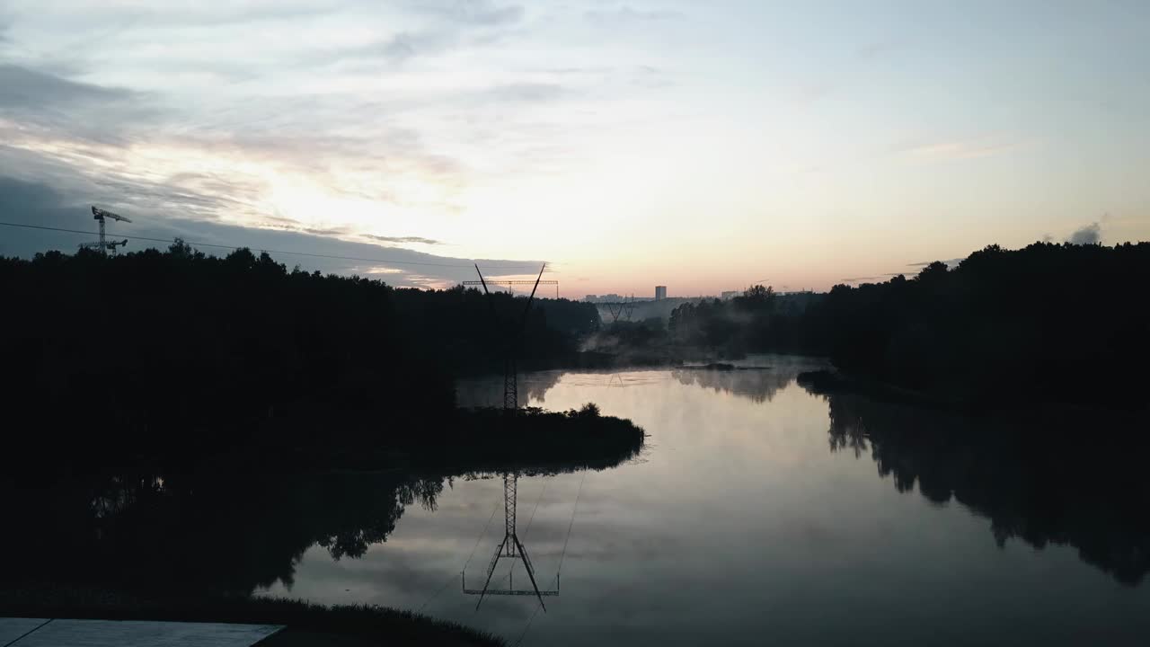 夜景拍摄的城市郊区，雾升到水面以上。来自四轴飞行器的酷镜头视频素材