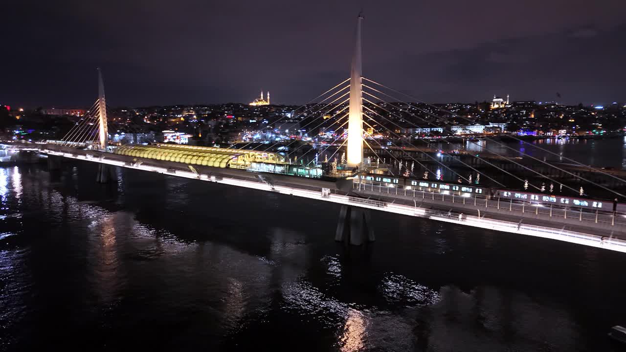 航拍夜的光辉:金角地铁大桥在城市灯光下照亮了#MetroBridgeMagic #夜景#IlluminatedSkies #无人机视图视频素材