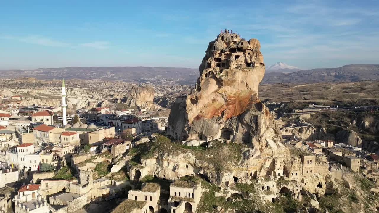 土耳其卡帕多西亚的Ortahisar城堡的空中无人机视图，背景是白雪覆盖的Erciyes山。视频下载