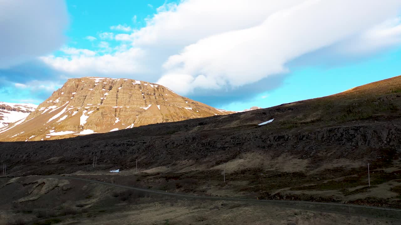 蓝天下的冰岛崎岖的山景和漂浮的云，无人机拍摄视频素材