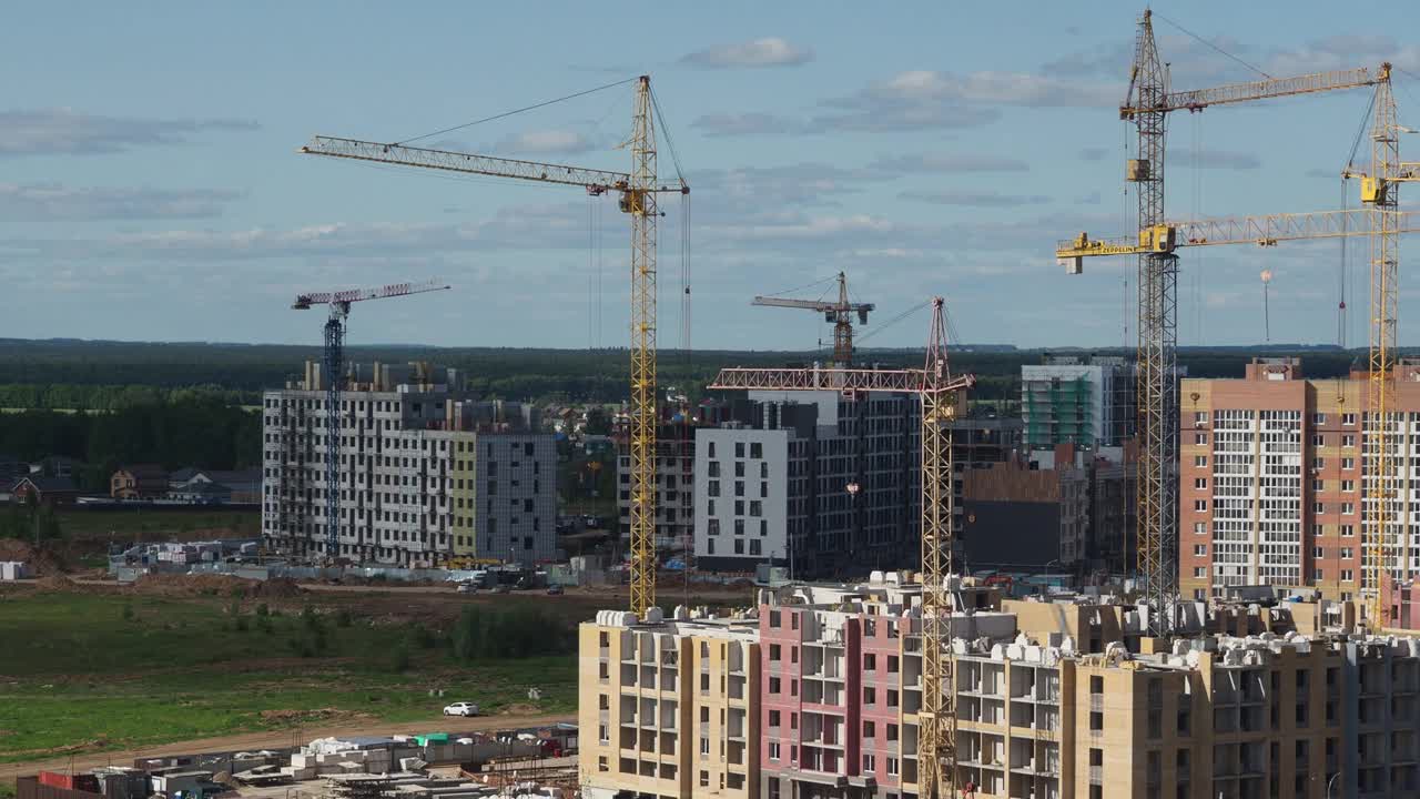 蓝天背景下的新建筑工地。钢框架结构、结构钢梁在施工现场建造大型建筑物。工程机械。现代城市视频素材