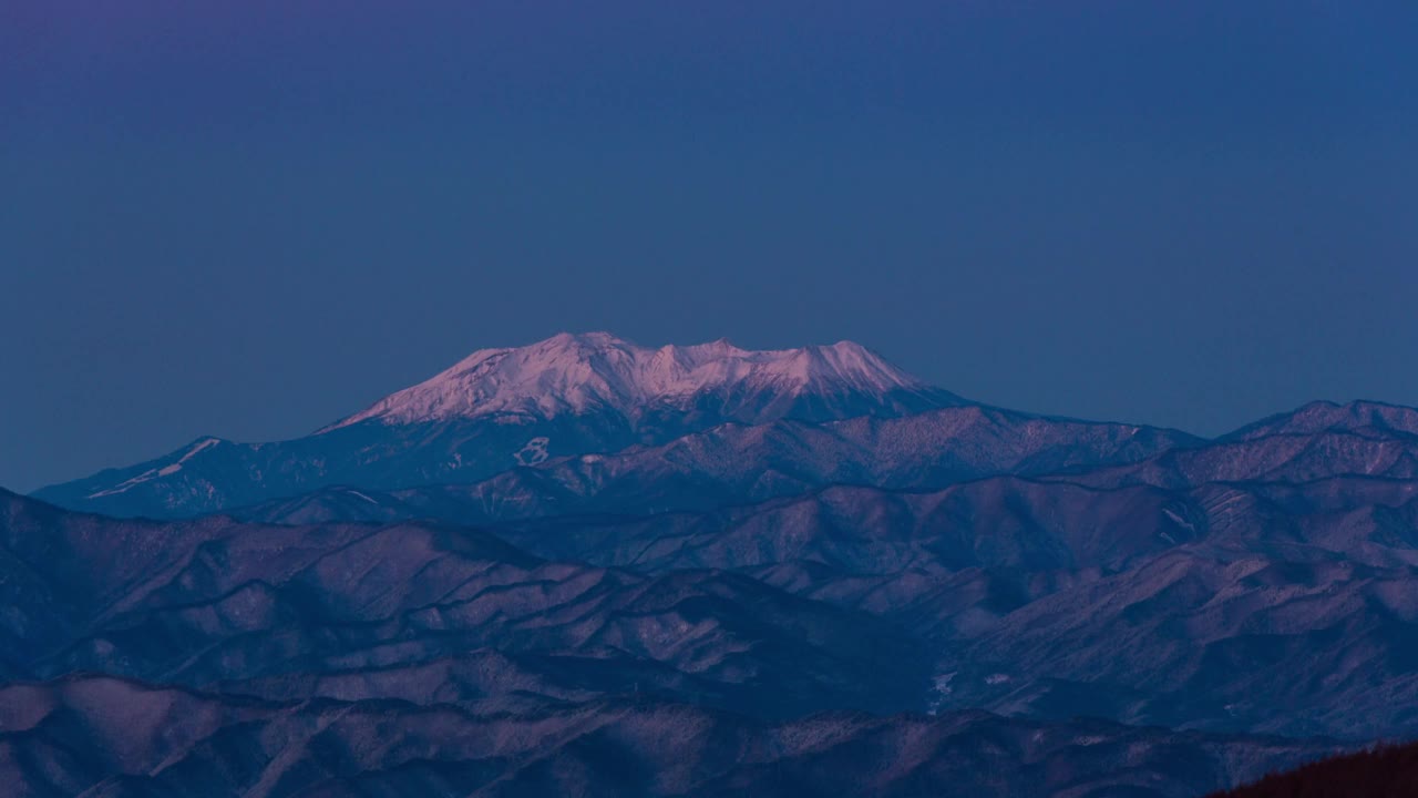 冬日里，从基利伽明高原上看，黎明时分的御岳山变成了粉红色视频下载