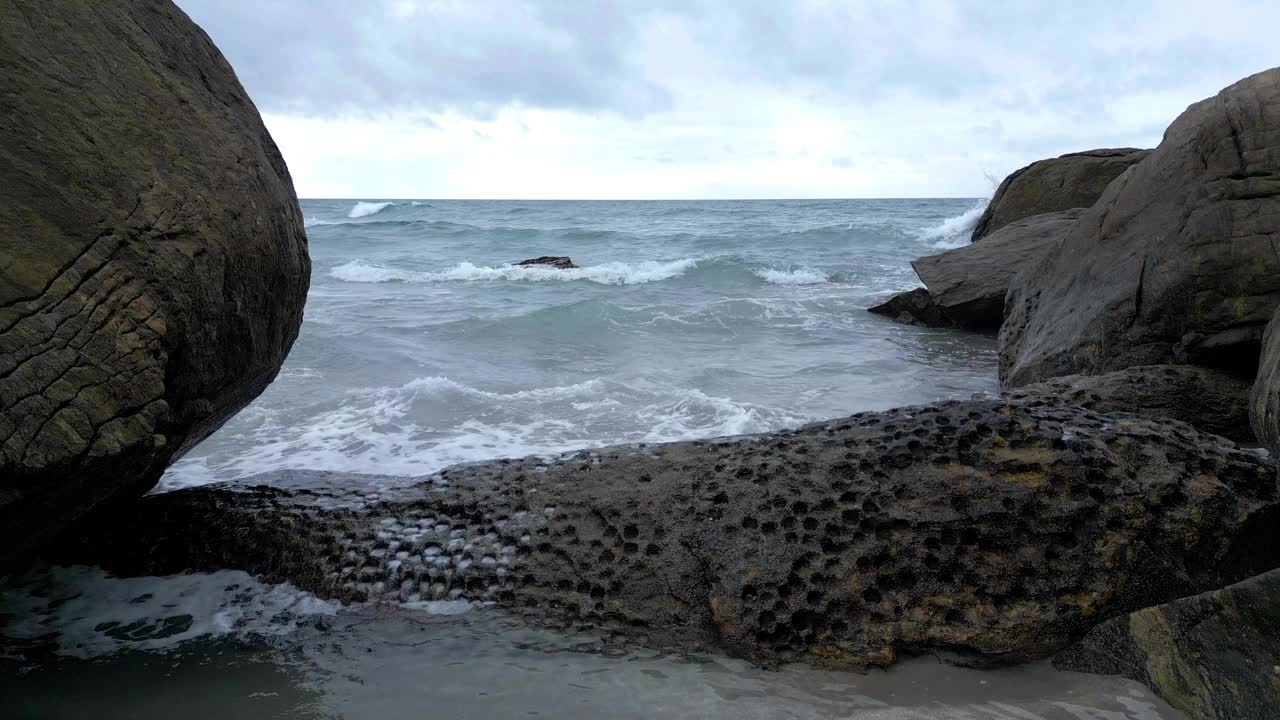 无人机航拍的热带海滩，海岸有波浪，树木，石头视频下载