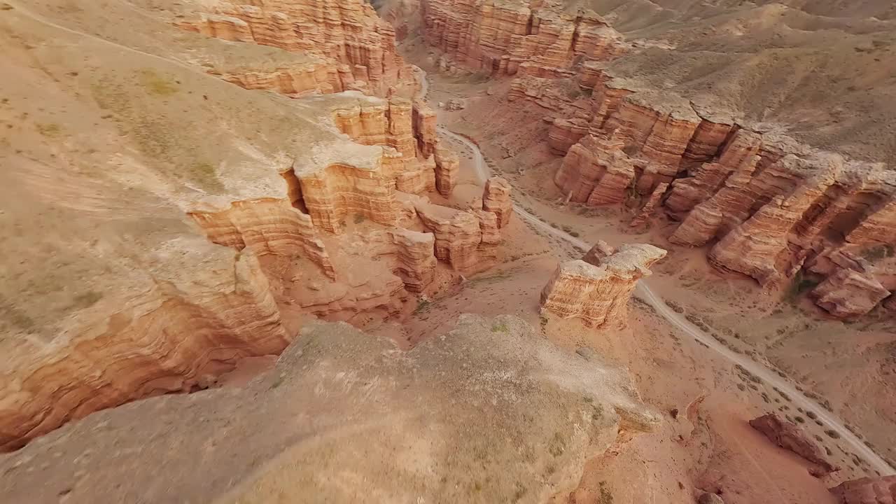 FPV无人机俯冲拍摄山地岩石地质地层石质结构速度坠落峡谷阳光自然鸟瞰图。悬崖地形电影海拔沙漠山谷景观。视频素材