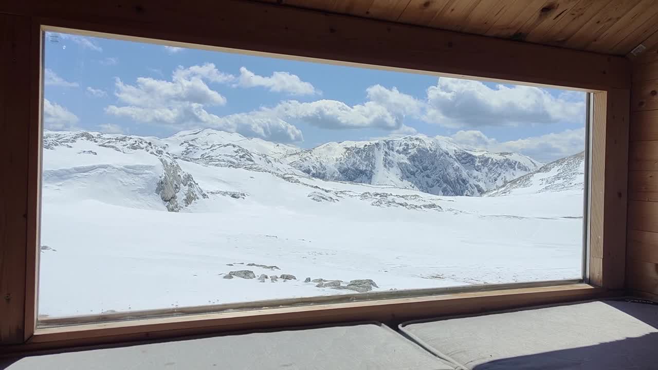 冬宫:冬季为徒步旅行者和登山者提供的山间庇护所的内部爬山活动。满山的雪。亲近自然。户外活动和旅游生活方式。视频下载