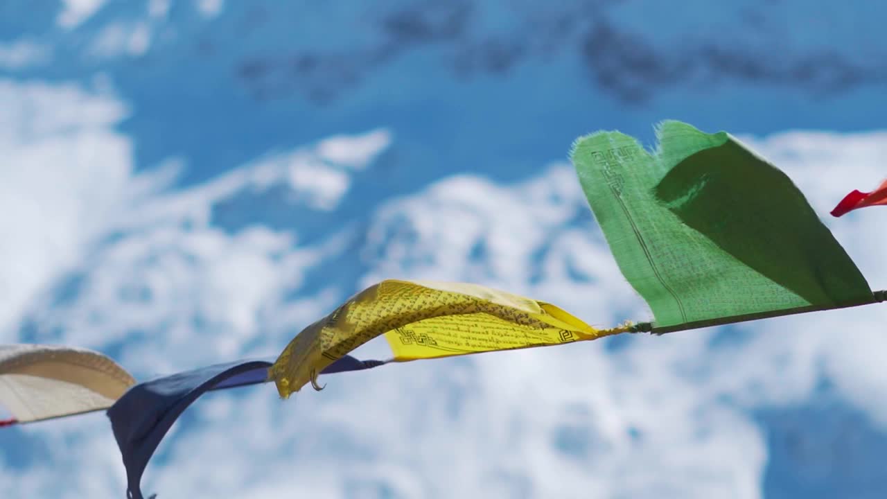 雪后，印度喜马偕尔邦拉胡尔山谷的西苏，雪后的喜马拉雅山峰前，祈祷旗在风中飘扬的慢镜头。视频素材