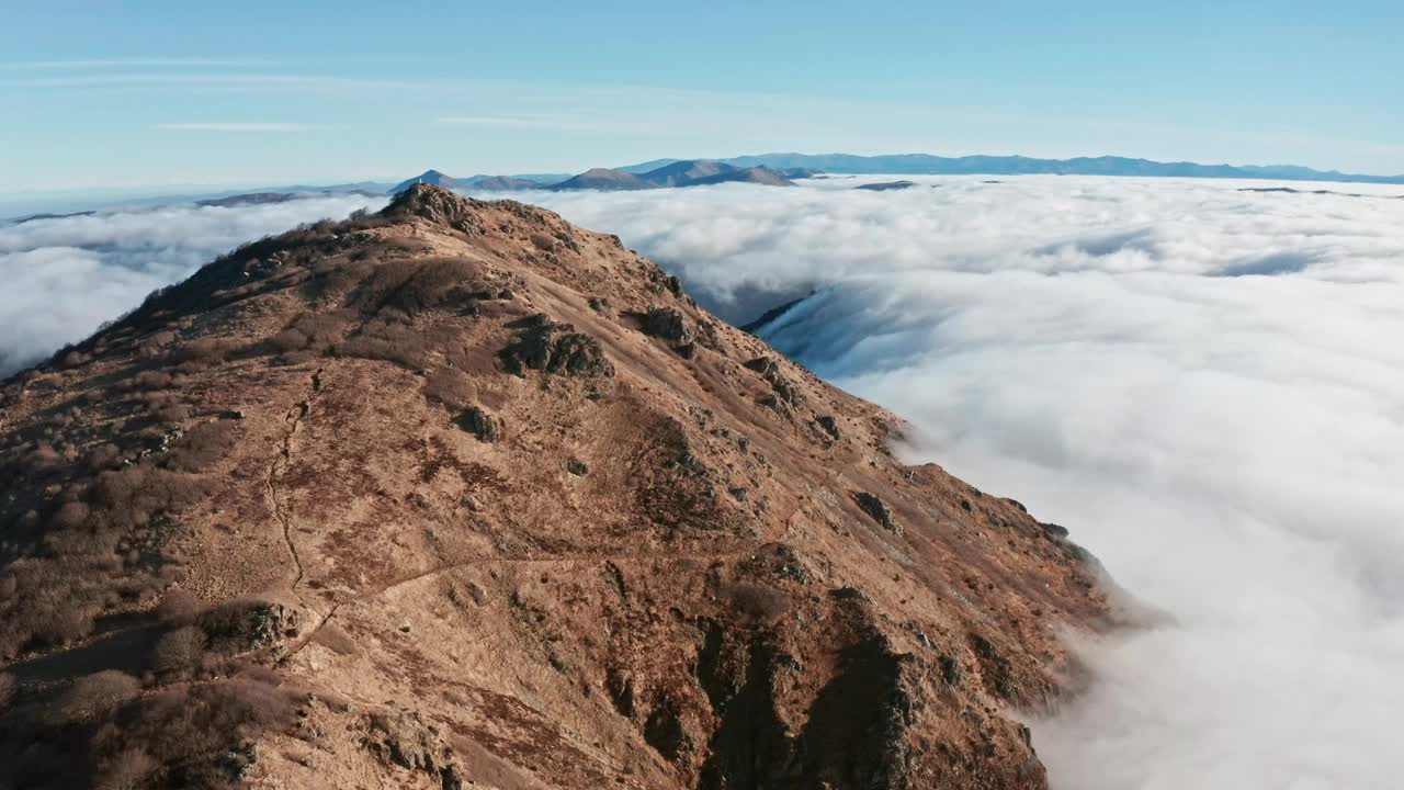 碧蓝晴空下，山峰高耸云海，广角航拍视频素材