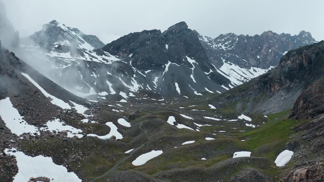 雾蒙蒙的山景，有雪片和山峦，可以看到涅拉湖视频素材