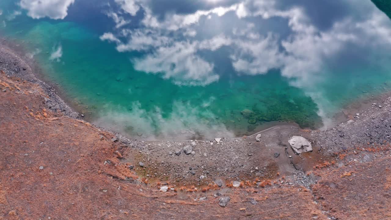 拉瓦迪莱克湖碧绿的湖水映着云彩，多山的地形，鸟瞰视频素材