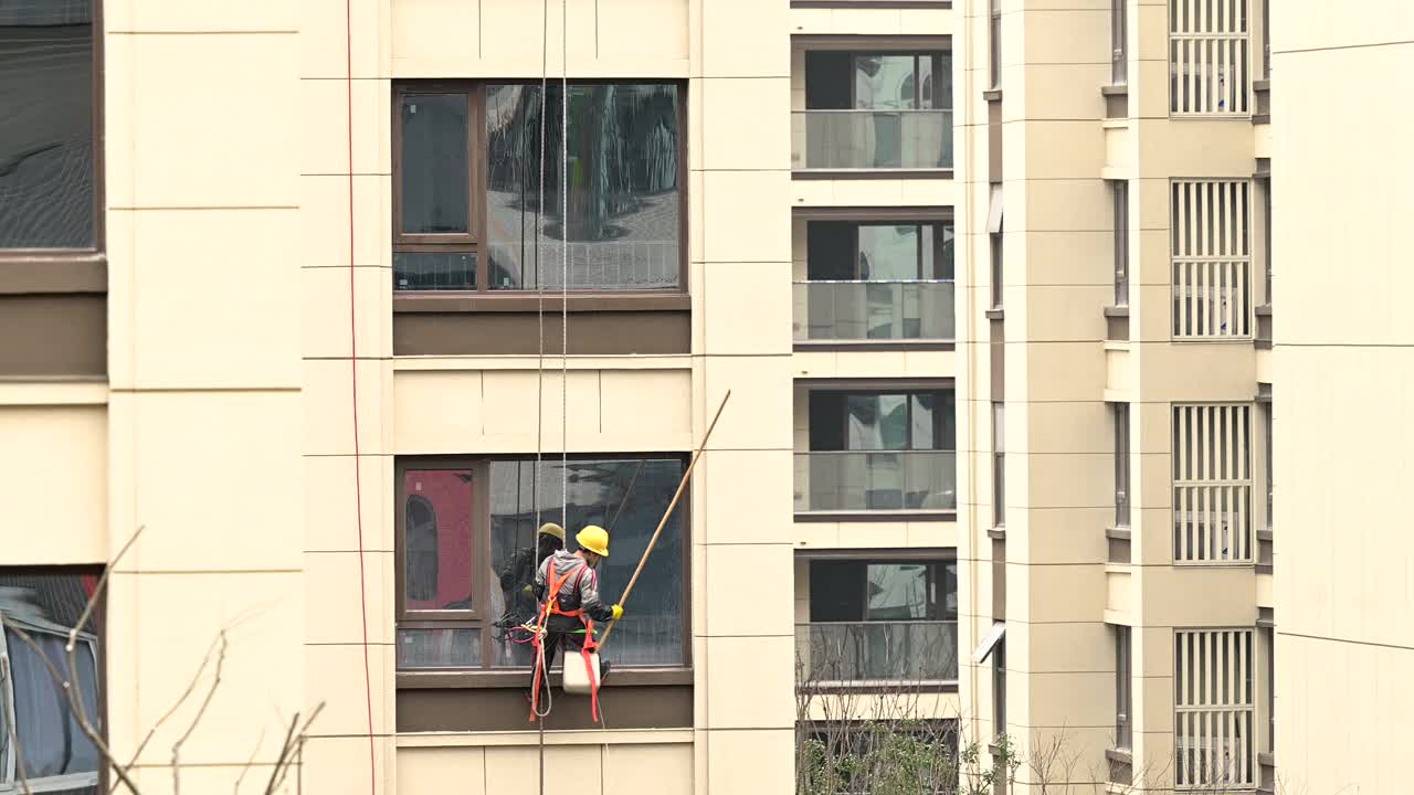 工人们在高层建筑外清洗玻璃视频下载