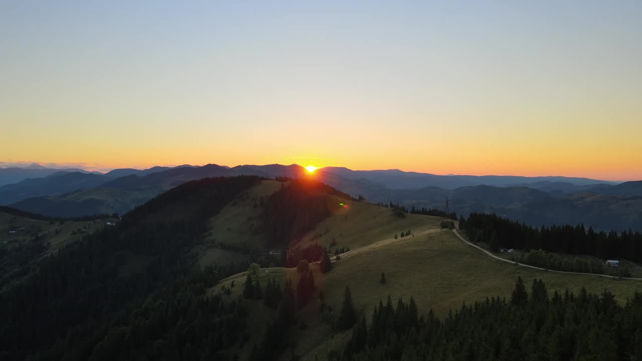 令人惊叹的山地景观。黑暗的云杉树林被黄色的夕阳照亮。在野生国家公园高地上明亮多彩的日落视频素材