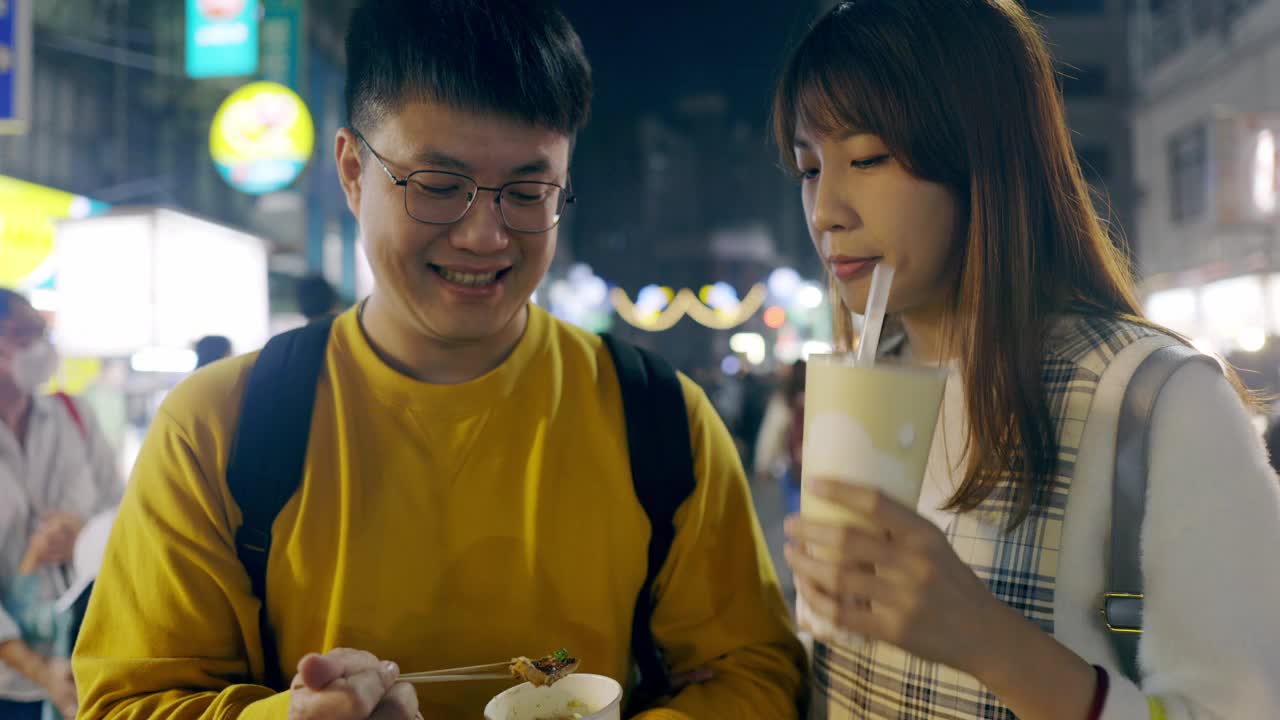 一对年轻的亚洲夫妇在台湾逛了当地著名的夜市，品尝了街头小吃视频下载