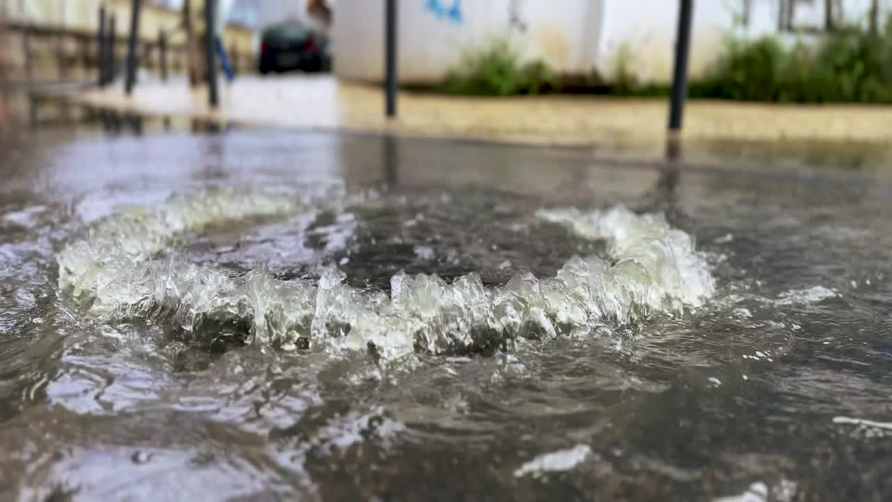 在一个下雨天，葡萄牙街道上的下水道盖满了水视频下载