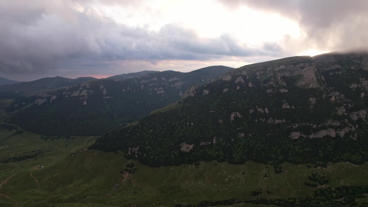 晚霞映在云雾缭绕的碧桂山上，鸟瞰郁郁葱葱的风景视频素材