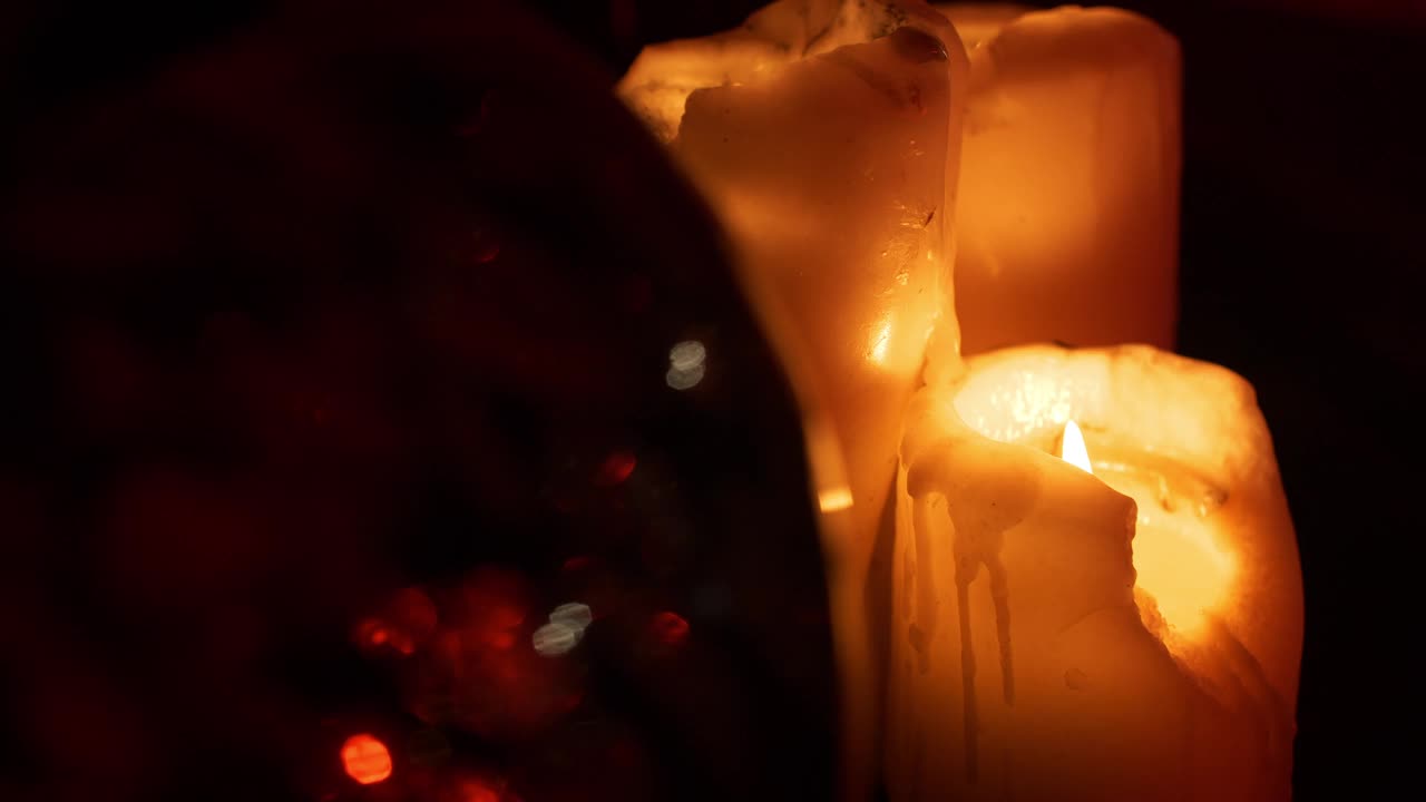 熔化的蜡烛燃烧在黑暗的气氛浪漫的设置视频素材