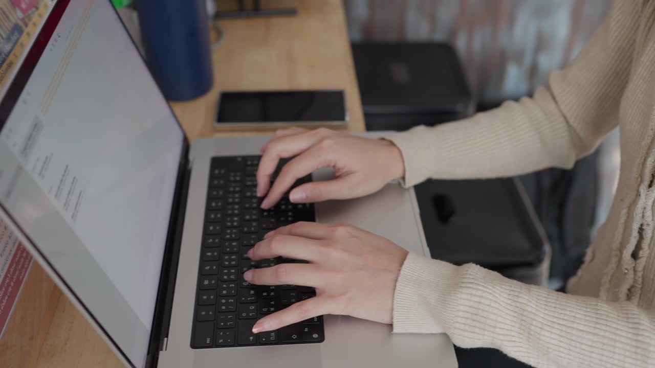 一位女士正在笔记本电脑上打字视频素材