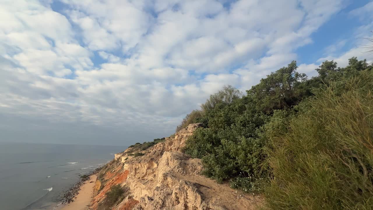 西班牙沿海地区的突出景观，崎岖的悬崖与拍打海岸的海浪形成鲜明对比，描绘了海边风景的自然美。视频素材