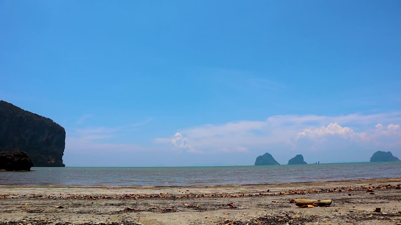 沙滩和大海在阳光明媚的一天，在泰国庄朝迈海滩视频素材