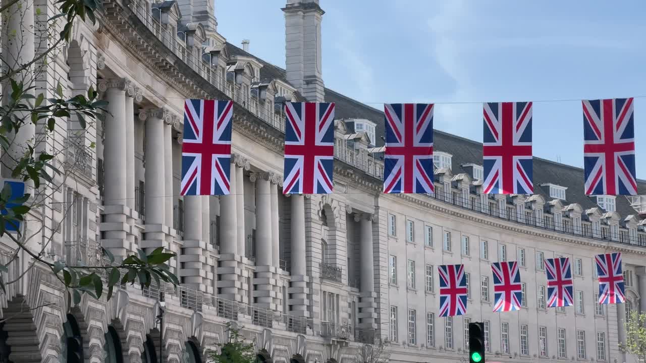 在一个阳光明媚的夏日，伦敦市中心摄政街的全景，英国国旗在街道上飘扬视频素材