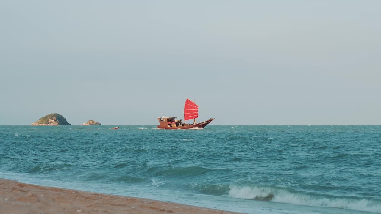 一艘长尾船在海上航行的风景视频素材