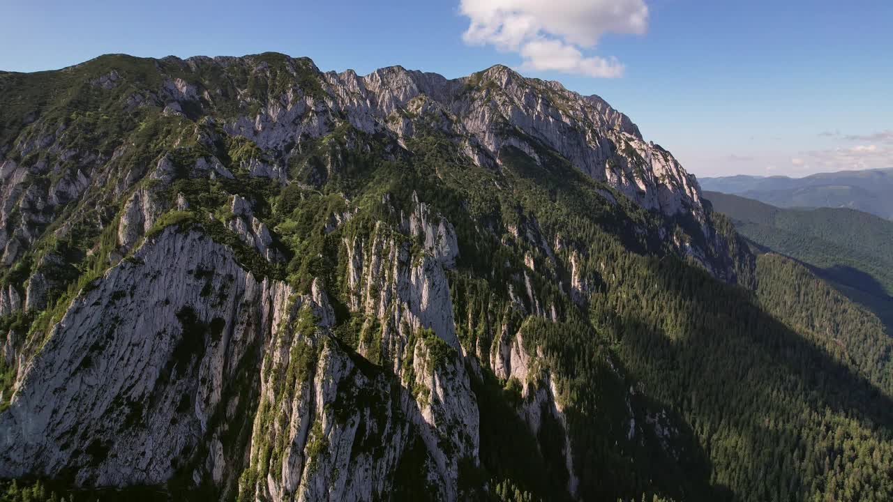 落日的余晖沐浴在皮亚特拉克雷乌伊崎岖的山峰上，鸟瞰大自然的壮丽视频素材